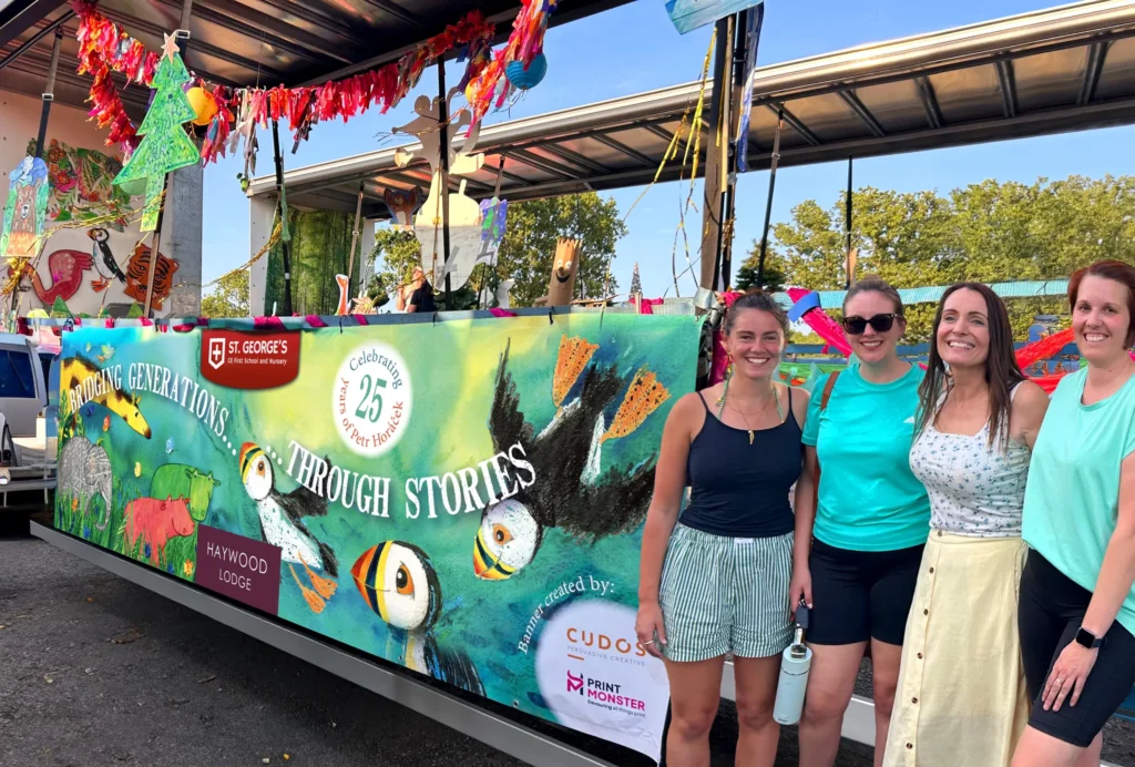 Printed carnival banner for St George’s and Haywood Lodge displayed on the side of a float