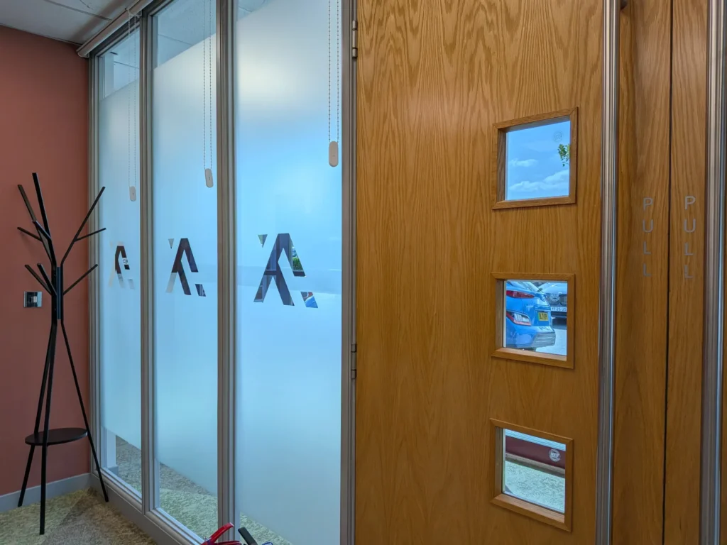 Finished frosted window graphics with Axil branding at a Cannock office.