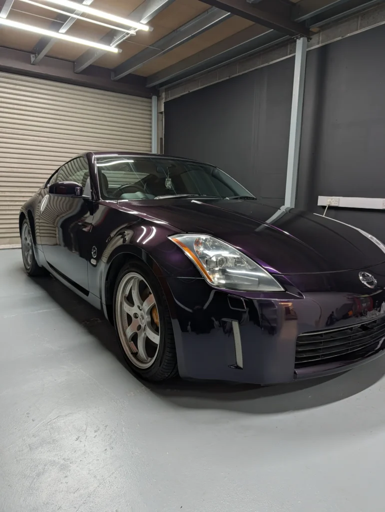 Front three quarter view of a Midnight Purple wrapped Nissan 350Z